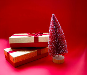 christmas tree and gifts on bright red background