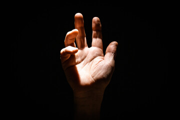 Man hand on a black background.