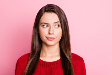 Photo portrait of suspicious unsure girl with straight brunette hair looking at side isolated on pink color background