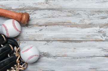 Baseball bat, glove and ball on wooden background.  Sport theme background with copy space for text and advertisment