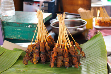 Lok Lok is a traditional street food in asia. Grilled skewer on banana leaf. 