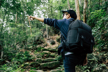 Traveler hike through forest to peak of mountain.