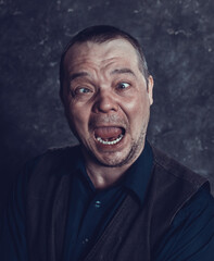 Middle aged social marginal emotional studio portrait.