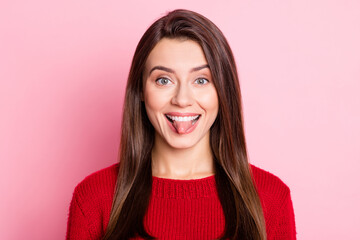 Fototapeta premium Photo portrait of funny brunette girl grimacing fooling showing tongue smiling isolated on pink color background