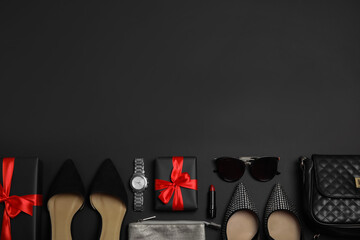 Gift boxes, shoes and stylish women's accessories on black background, flat lay. Space for text