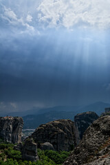 Meteora, Greece with the beautiful rocks under a cloudy day with beautiful rays of light