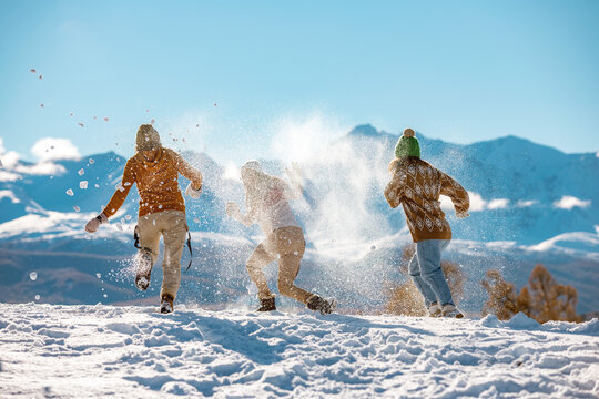 Three Young Girls Friends In Snow Fight