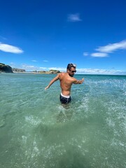 boy in the sea make splash. Sunny day