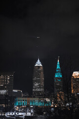 Cleveland ohio skyline at night with a ship on the cuyahoga river