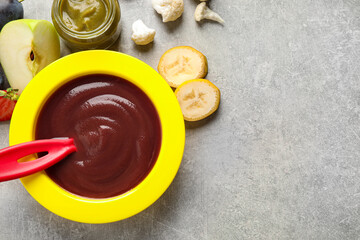 Healthy baby food on grey table, flat lay. Space for text