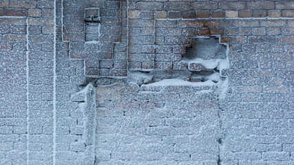 Old rough snow covered brick wall texture