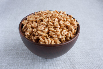 delicious airy wheat in honey glaze in a clay bowl