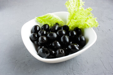 seedless black olives in a bowl on the table