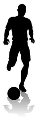A soccer or football player in silhouette