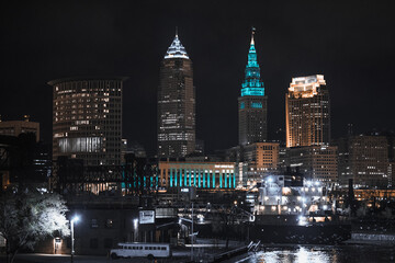Cleveland ohio skyline at night with a ship on the cuyahoga river