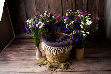 the basket is decorated with flowers. basket for a newborn photo shoot. background for a photo shoot	