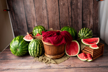 the basket for the photo shoot is decorated with watermelons. basket for newborn photo sessions. background decor of a photo zone with watermelons. red watermelon