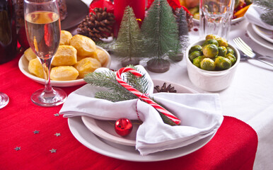 Christmas table setting with holiday decorations. New Year celebration.