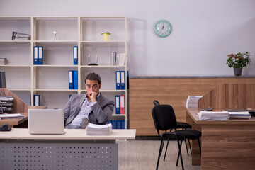 Young male employee working in the office