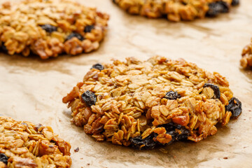 Homemade oatmeal cookies are aromatic and tasty on parchment paper.