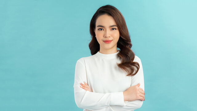 Image of happy young business woman posing isolated over blue wall background.