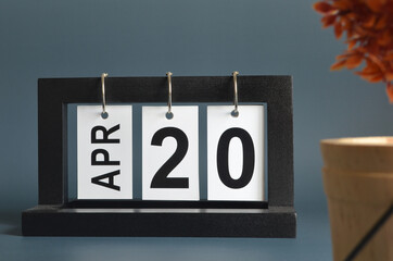 April 20, Date design with a black wooden calendar for a business, Date Plans to remind.