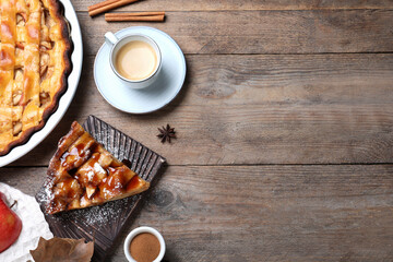 Slice of traditional apple pie served on wooden table, flat lay. Space for text