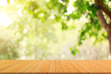 wooden table and green nature bokeh background.