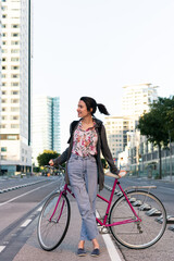 Fototapeta na wymiar young girl with a retro bicycle in the bike path