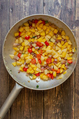 A typical neapolitan dish, potato and pasta, with bacon and tomatoes.