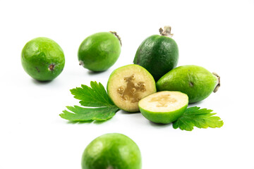Composition with tropical feijoa or acca sellowiana, pineapple guava fruit ripe and cut on white isolated background