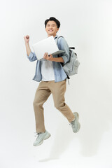 Jumping male Asian programmer with laptop on white background