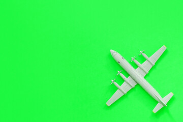 a toy plane on a bright colored background, the concept of resuming flights around the world after the coronavirus, restoring the finances of airlines and tour operators.