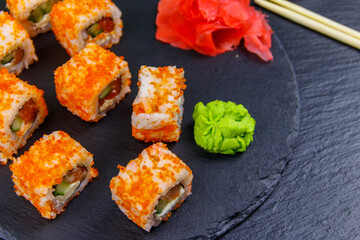 Sushi rolls Philadelphia on a black slate