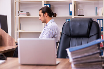 Fototapeta premium Young male employee working in the office