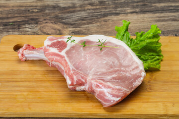 Raw pork bone steak over wooden