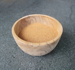 cinnamon powder with wood bowl