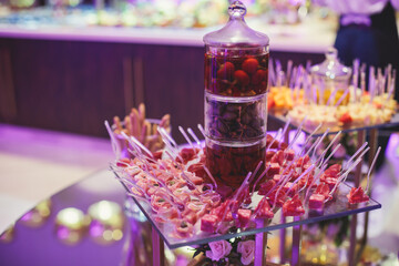 Beautifully decorated catering banquet table with variety of vegetables and different vegan vegetarian snacks on corporate christmas birthday party event or wedding celebration