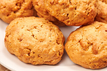 Cookies in white ceramic dish on wood board Close up