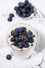 bircher muesli with fresh blueberries on white table, top view