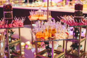 Beautifully decorated catering banquet table with variety of vegetables and different vegan vegetarian snacks on corporate christmas birthday party event or wedding celebration