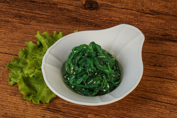 Green Chuka Seaweed Salad Isolated on White Background Top View. Wakame Sea Kelp Salat