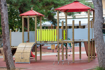 Fototapeta na wymiar Playground near trees in yard, Place for kids fun