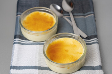 Delicious Crème brûlée presentation with two spoons .Burnt cream or creme brulee is a famous french dessert with caramelized sugar, similar as Spanish 'Crema catalana' .