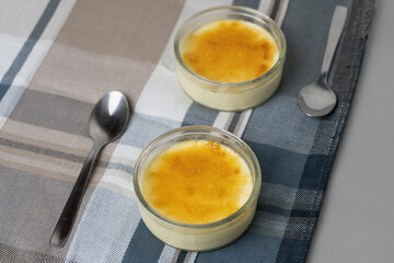 Crème brûlée or burnt cream, presentation with two spoons .Delicious dessert famous in France , similar as Spanish 'Crema catalana' .