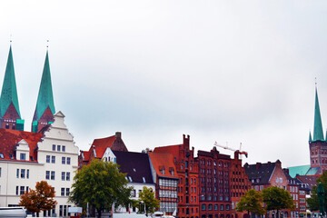 Old town Lubeck on a white background. Embankment of the river Trave, Germany.