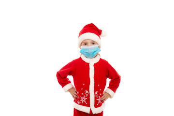 Little boy dressed as santa claus wearing a medical mask