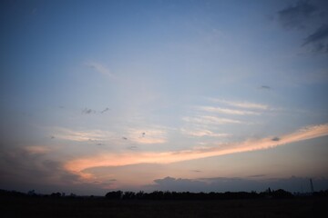 Blue sky with sunset pink clouds