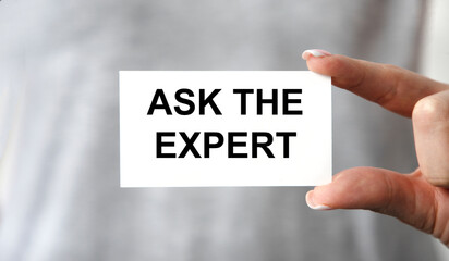 The businessman holds a business card with the text ASK THE EXPERT.