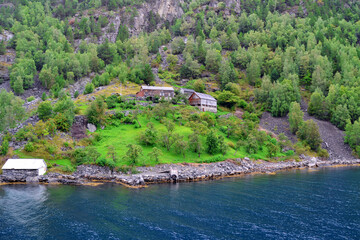 Norwegian fjord, rustic houses and mountain in summer. Natural rural landscape view, Flam, Norway